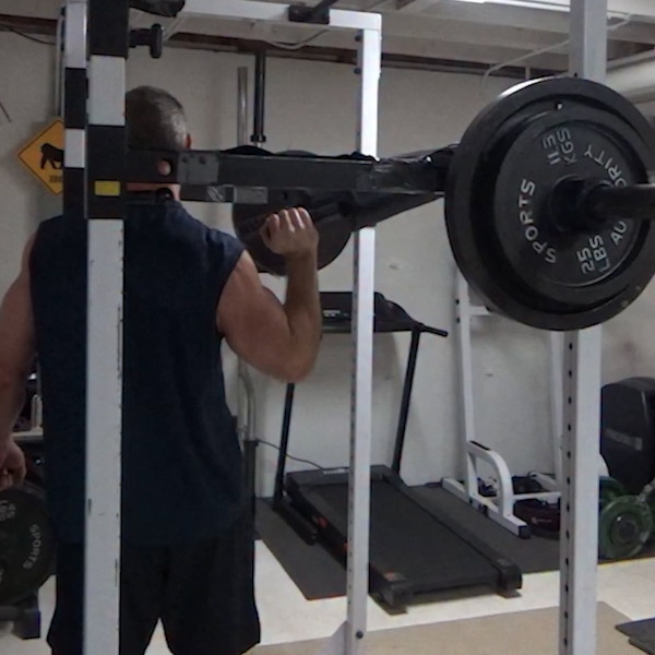 Safety Squat Bar Rotary Press for Side Delt Focus